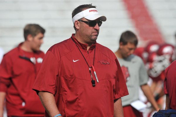 Arkansas coach Bret Bielema watches his team warm up for practice Saturday, Aug. 9, 2014, at Razorback Stadium in Fayetteville.