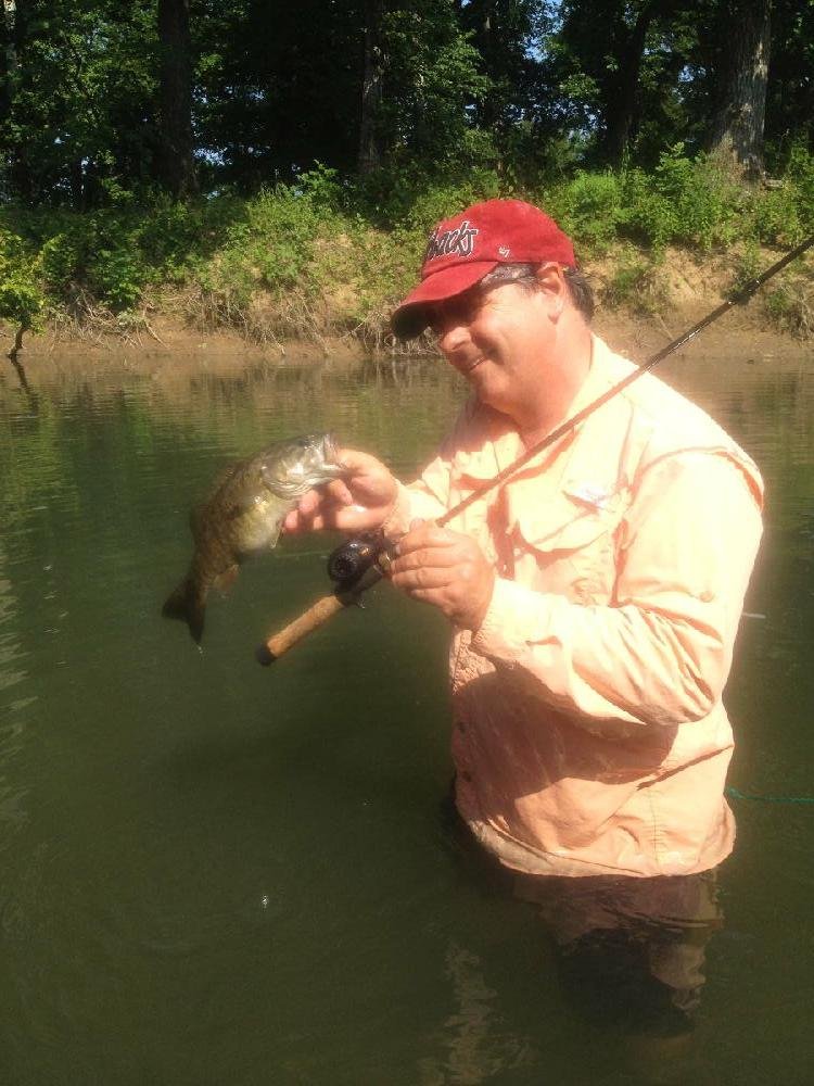 Bryan Hendricks holds up a smallmouth bass he caught Wednesday on the South Fork of the Spring River.