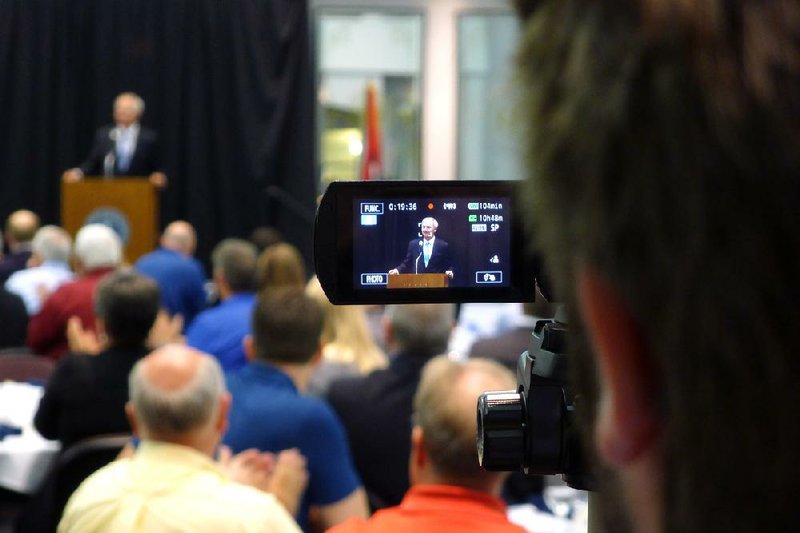 A video tracker for the Democratic Party records Republican gubernatorial candidate Asa Hutchinson from the back of the room Friday during a campaign stop in Fort Smith.
