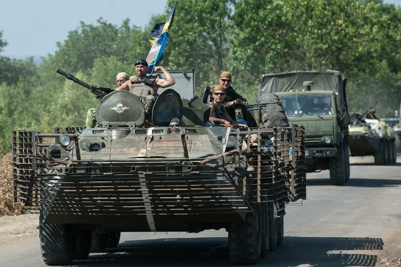 Ukrainian government forces roll Saturday through eastern Ukraine near the rebel stronghold of Donetsk, which they now have surrounded. Rebel leader Aleksandr Zakharchenko said his fighters are ready for a cease-fire to prevent a “humanitarian catastrophe,” but his motives were not clear, officials said. 