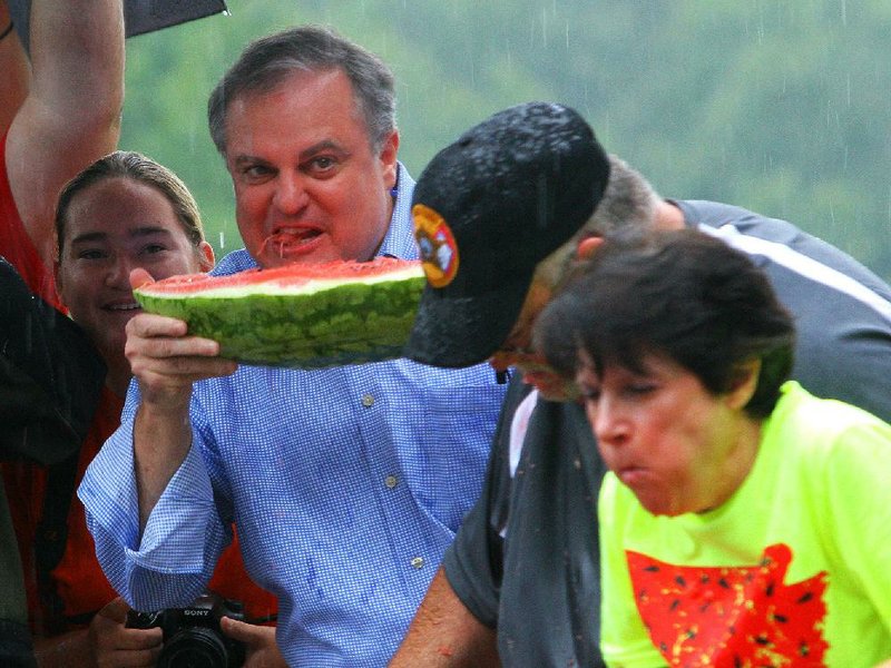 8/9/14
Arkansas Democrat-Gazette/STEPHEN B. THORNTON
Sen. Mark Pryor munches on a slice as he checks out his competition during the Politically Correct Watermelon Eating Contest Saturday morning at the Hope Watermelon Festival in Hope.