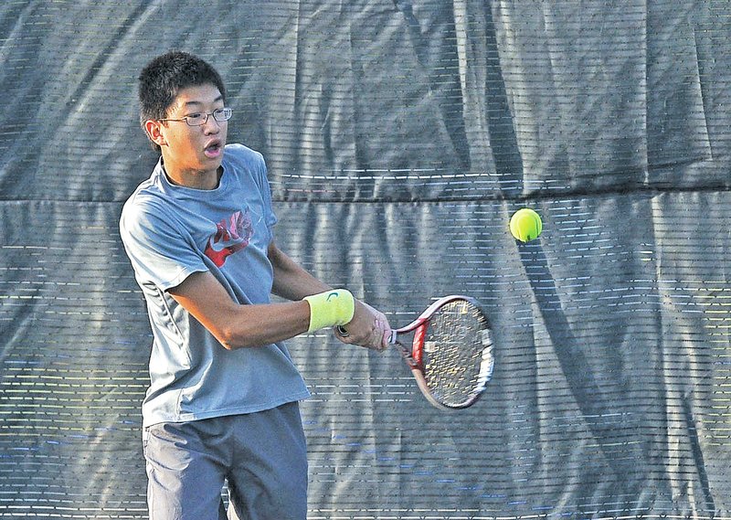  STAFF PHOTO FLIP PUTTHOFF Michael Zheng practices on Wednesday with the Rogers High tennis team. Zheng is battling for the top singles spot for Mounties this season.