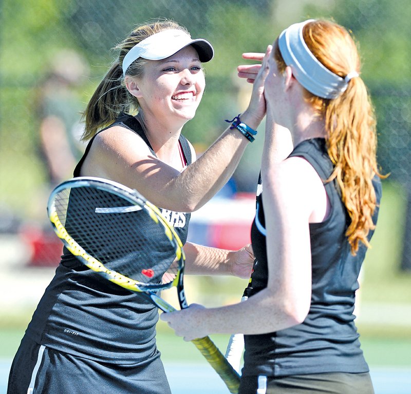  STAFF PHOTO ANTHONY REYES Kendra Dinsmore, left, and Mallory Tabler, both of Bentonville, celebrate a point during the 7A West conference tennis tournament Oct. 10 at Memorial Park in Bentonville.
