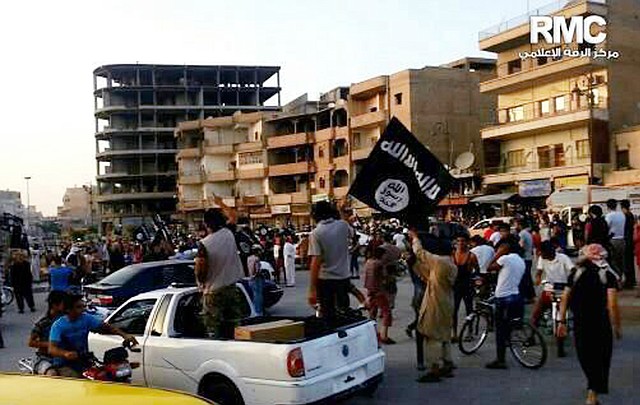 This undated file photo posted by the Raqqa Media Center, a Syrian opposition group, on Monday, June 30, 2014, which has been verified and is consistent with other AP reporting, shows fighters from extremist Islamic State group during a parade in Raqqa, Syria. Activists have reported two cases of stoning this month in the Syrian northern province of Raqqa. The first case of stoning occurred in the town of Tabqa. A day after the July 17, 2014, stoning of Shamseh Mohammed Abdullah, 26, Faddah al-Sayed Ahmad was stoned to death in the provincial capital of Raqqa.