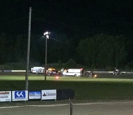 This image provided by Logan Messerly shows ambulances on the scene at Canandaigua Motorsports Park on Saturday Aug. 9, 2014 in Canandaigua, N.Y. Authorities are investigating a serious crash that injured one person at a New York dirt track where Tony Stewart was racing on the eve of a NASCAR race. 