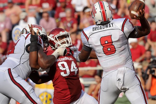 Arkansas defensive end Taiwan Johnson puts the pressure on the quarterback during the game against the Louisiana Ragin' Cajuns, Saturday, Aug. 31, 2013, at Razorback Stadium in Fayetteville.
