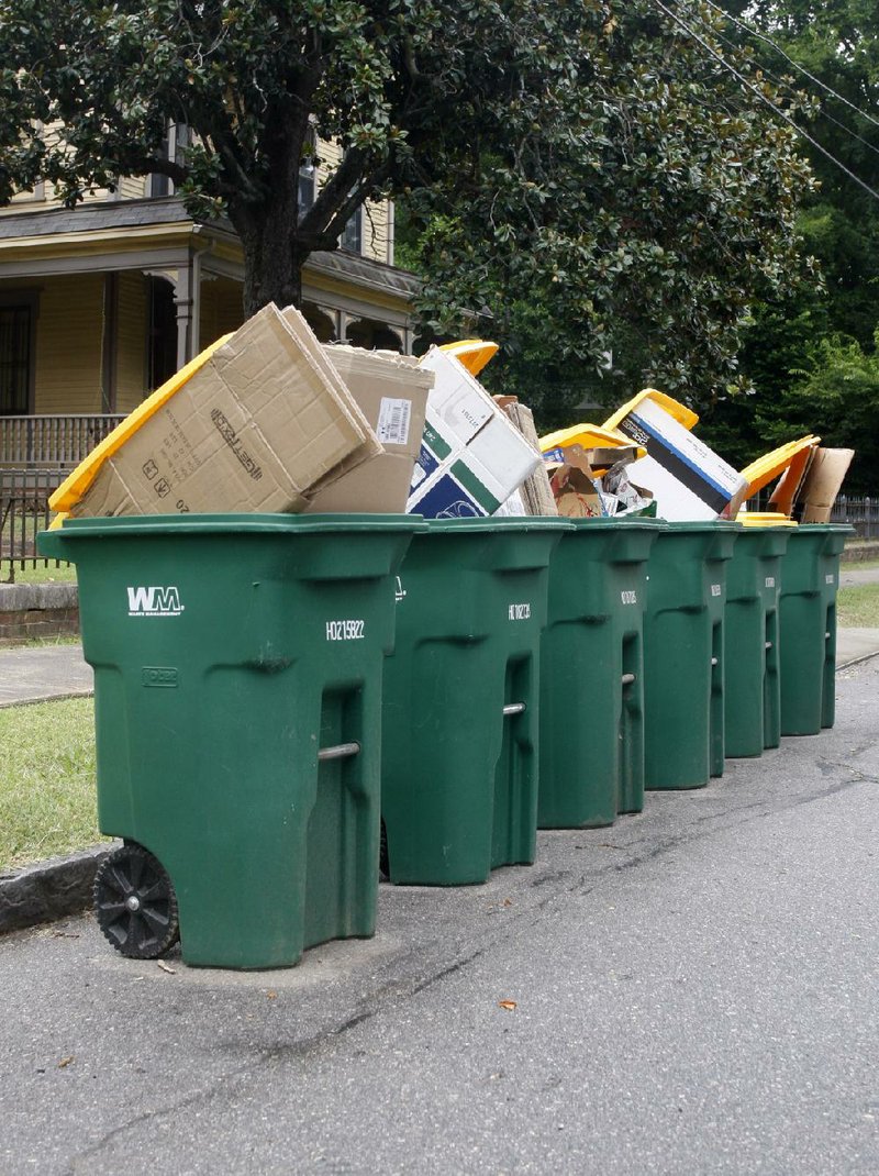 Arkansas Democrat Gazette/JEFF MITCHELL - 08/07/2014 - Curbside residential recycle containers sit on East Seventh Street in downtown Little Rock on pick-up day, August 7, 2014.