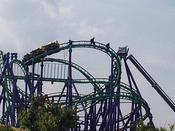 This image provided by Prince George's County Fire Dept. shows firefighters reaching riders stranded on a roller coaster at Six Flags America in Upper Marlboro, Md., Sunday, Aug. 10, 2014. (AP Photo/Prince George's County Fire Dept., Marc Bashoor)