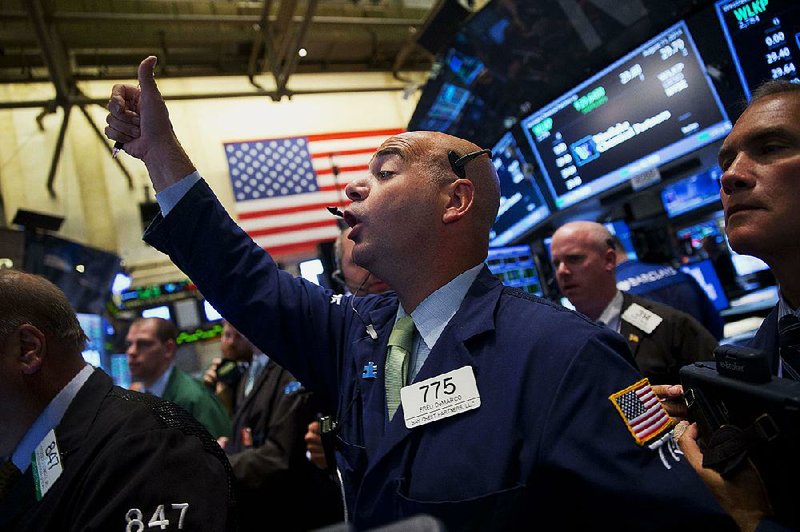 Traders work on the floor of the New York Stock Exchange (NYSE) in New York, U.S., on Monday, Aug. 11, 2014. Global stocks rose the most since April while bonds fell as tension eased in Ukraine and the U.S. showed signs of pushing back militants in Iraq. Photographer: Jin Lee/Bloomberg