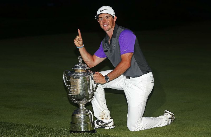 Rory McIlroy, of Northern Ireland, holds up the Wanamaker Trophy after winning the PGA Championship golf tournament at Valhalla Golf Club on Sunday, Aug. 10, 2014, in Louisville, Ky.  (AP Photo/Mike Groll)