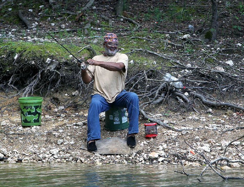 Gerald Bryant of Hot Springs, Ark., fishes on Lake Ouachita at the Joplin Use Area Monday, August 11, 2014. (The Sentinel-Record/Richard Rasmussen)