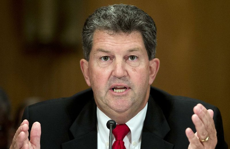 Postmaster General Patrick Donahoe gestures as he speaks during the Senate Homeland Security and Governmental Affairs Committee hearing on Capitol Hill, Thursday, Sept. 19, 2013, in Washington. According to Donahoe, the Postal Service may need an emergency rate increase to stay afloat. (AP Photo/Carolyn Kaster)