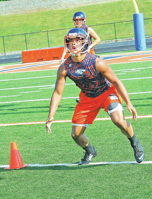 STAFF PHOTO FLIP PUTTHOFF Joey Saucier fields a punt Aug. 5 during practice for Rogers Heritage.