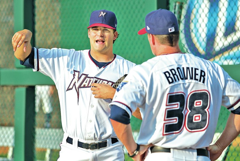 STAFF PHOTO JASON IVESTER Andrew Triggs, Naturals reliever, talks Aug. 5 with pitching coach Jim Brower before their game against Corpus Christi at Arvest Ballpark in Springdale.