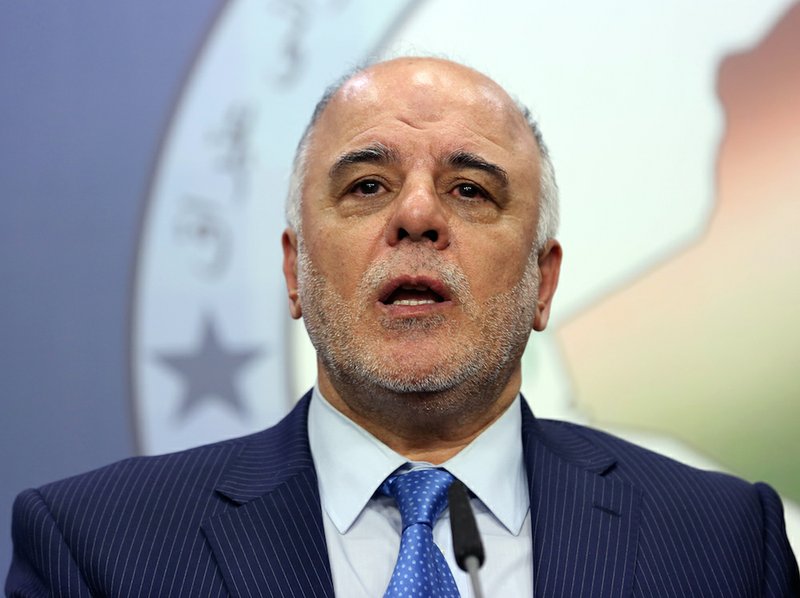 In this Tuesday, July 15, 2014 file photo, Shiite lawmaker and Deputy Parliament Speaker Haider al-Abadi speaks to the media after an Iraqi parliament session in Baghdad. 