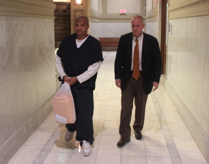 Darrell Dennis is escorted into court Tuesday morning.
