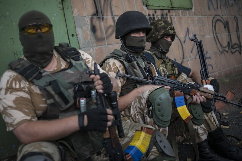 Ukrainian government soldiers from battalion "Donbass" rest at their positions in village Mariinka near Donetsk, eastern Ukraine, on Monday, Aug. 11, 2014. The Red Cross will lead an international humanitarian aid operation into Ukraine’s conflict-stricken province of Luhansk with assistance from Russia, the European Union and the United States, Ukraine said Monday.