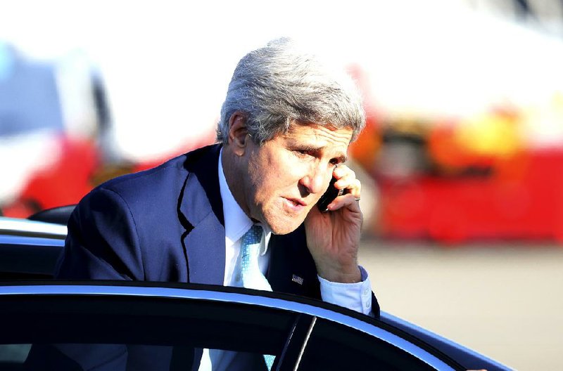 Secretary of State John Kerry takes a call at the airport in Sydney as he prepares to depart Australia.