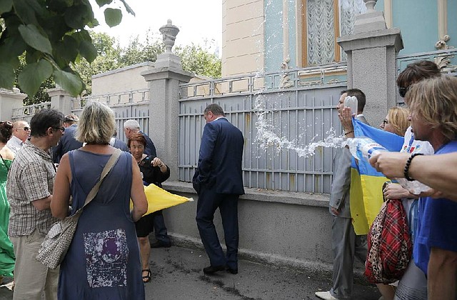 Activists throw water at lawmakers during a demonstration Tuesday to demand sanctions against Russia, near the parliament building in Kiev, Ukraine.
