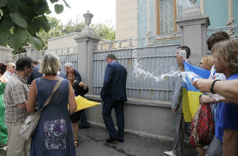 Activists throw water at lawmakers during a demonstration Tuesday to demand sanctions against Russia, near the parliament building in Kiev, Ukraine.