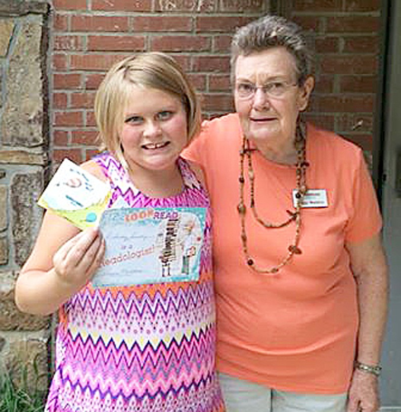 Photograph submitted Delaney Busby won the summer reading program prize from the Pea Ridge Community Library. Librarian Mrs. Peggy Maddox presented her with a prize for reading 65 books.