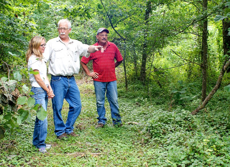 Photo by Randy Moll Paul Lemke, mayor of Springtown, explains to Misty Murphy, regional trails coordinator for Northwest Arkansas Council, and Terry Stanfill, manager of the Eagle Watch Nature Area, plans to build a 1.24 mile walking trail on land owned by John Wasson and Springtown.