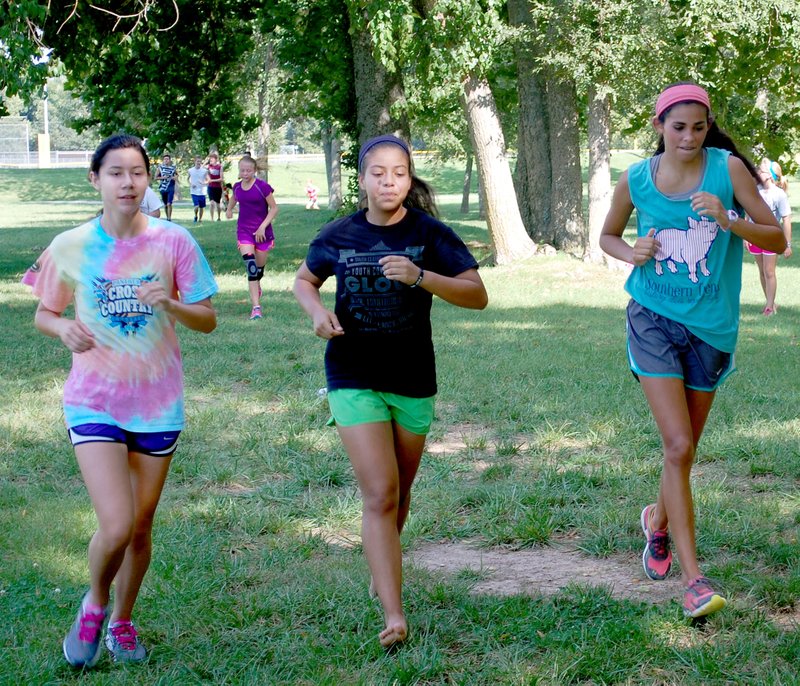 Graham Thomas/Herald-Leader Siloam Springs cross country runners, from left, senior Adrienne McGooden, junior Laura Gutierrez and junior Alexis Duffy are three of the Lady Panthers&#8217; top runners for 2014.
