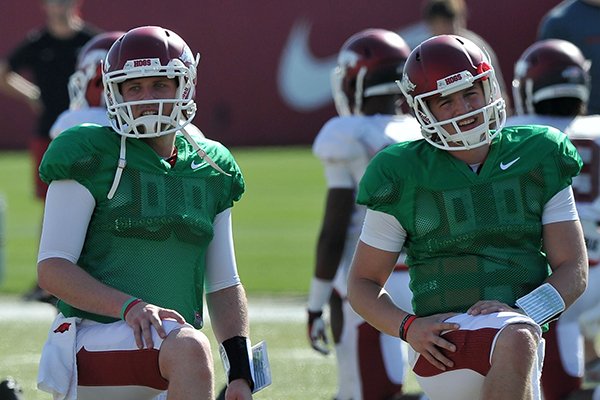 Arkansas quarterbacks Austin Allen (left) and Rafe Peavey stretch prior to an April 20, 2014 practice in Fayetteville. 