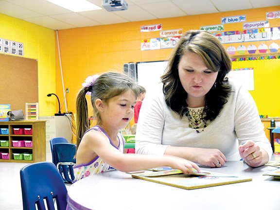 White County Central School District’s new elementary principal, Beverly Froud, works on a jigsaw puzzle with student Emma Roberts. The school will begin the Arkansas A+ program for the 2014-15 school year. The program uses art in classroom instruction.