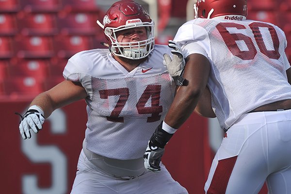 Arkansas offensive tackle Brey Cook runs a drill during practice Saturday, Aug. 9, 2014 at Razorback Stadium in Fayetteville. 