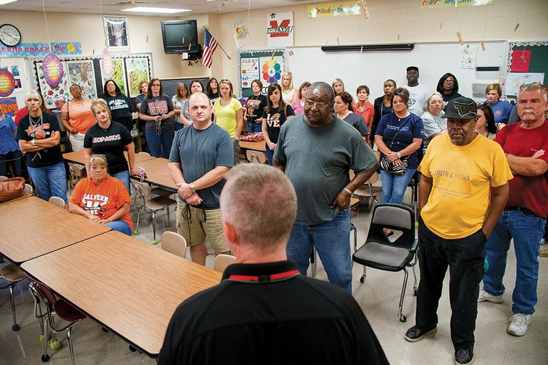 A group of Malvern school employees listen to Jerry Cooley, a Kansas City, Missouri, police officer and an instructor with Strategos, on how to deal with weapon-wielding school intruders through various access-denial techniques.