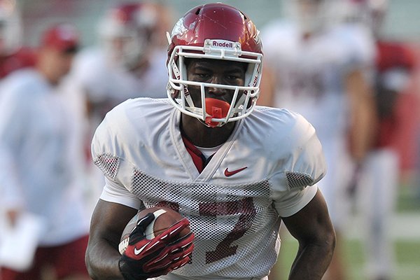 Arkansas receiver JoJo Robinson runs with the football during a practice Wednesday, Aug. 13, 2014 at Razorback Stadium in Fayetteville. 