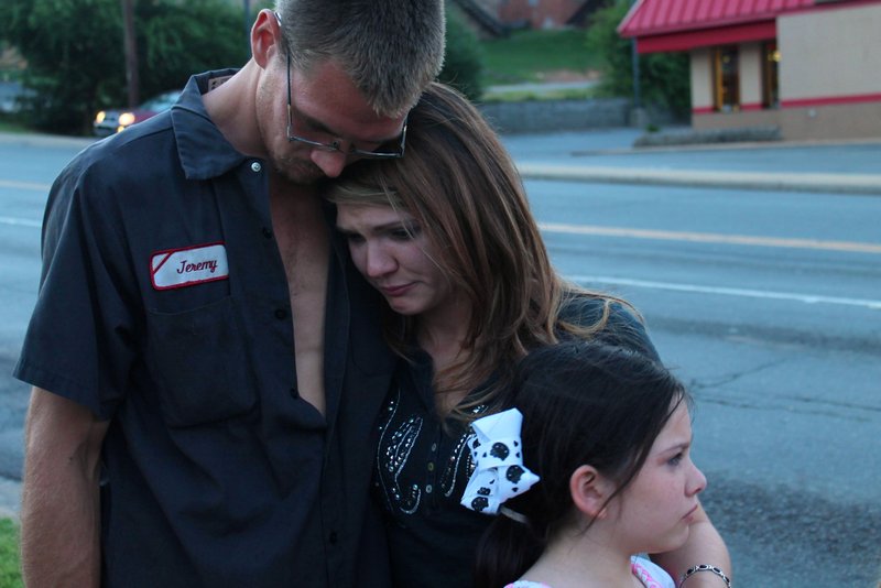 Samantha Olson's brother Jeremy Welshhons, sister, April Welshhons and neice, comfort each other as Olson's memorial comes to a close. Olson was shot and killed a year earlier while driving out of a Walgreen's parking lot in North Little Rock with her 11 month daughter. 