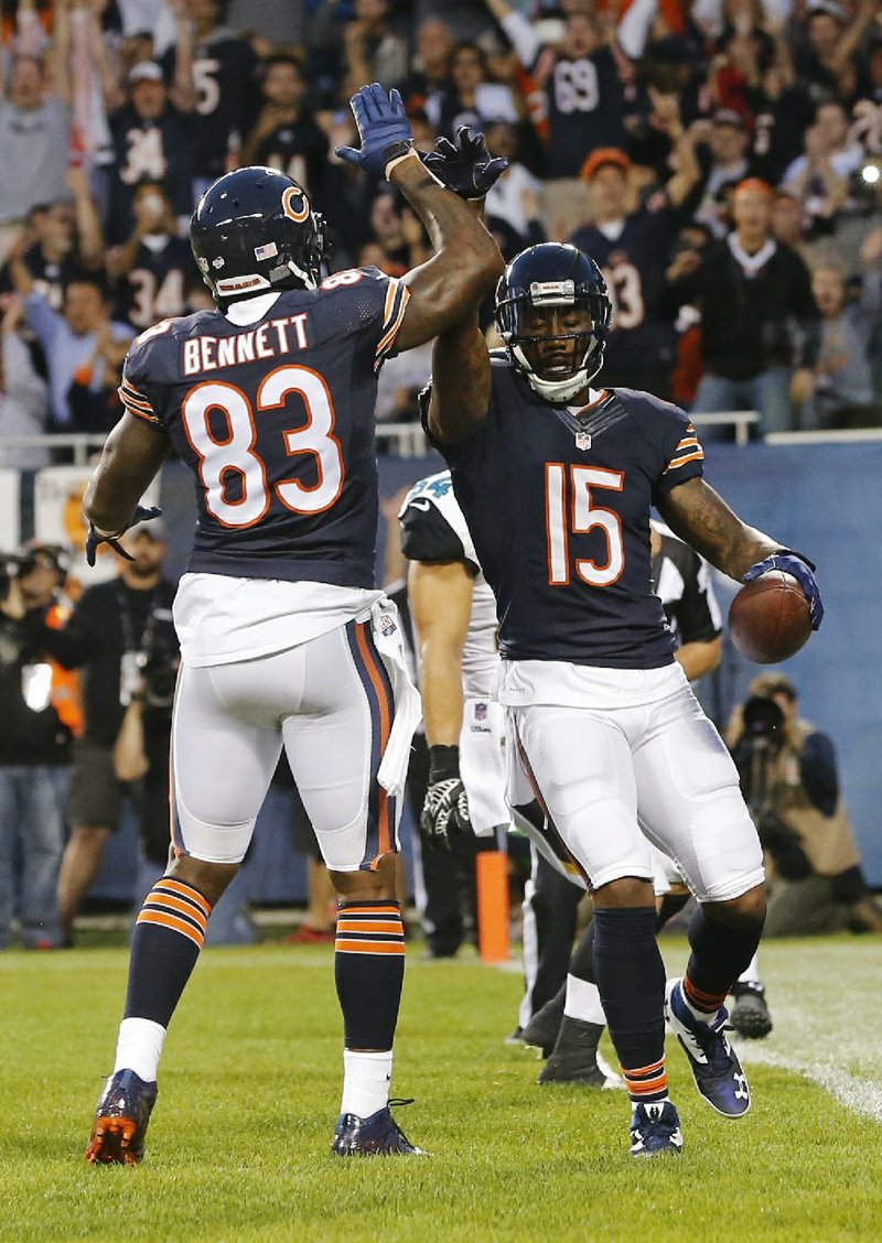 Chicago Bears wide receiver Brandon Marshall (15) celebrates his touchdown reception with teammate Martellus Bennett (83) during the first half of an NFL preseason football game against the Jacksonville Jaguars in Chicago, Thursday, Aug. 14, 2014. (AP Photo/Charles Rex Arbogast)