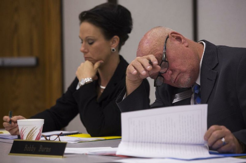 Arkansas Democrat-Gazette/MELISSA SUE GERRITS - 08/14/2014 -  Embalmers and Funeral Director's Board member Bobby Burns, looks over paper work while discussing his feelings over the building of a crematorium about 400 feet from a public school at a meeting August 14, 2014. Board Inspector, Leslie Stokes, sits at his right.  The board met to vote on a permit for a crematorium in Russellville after many residents spoke out against it during a 3 hour public hearing. The vote was tabled for a later meeting. 
