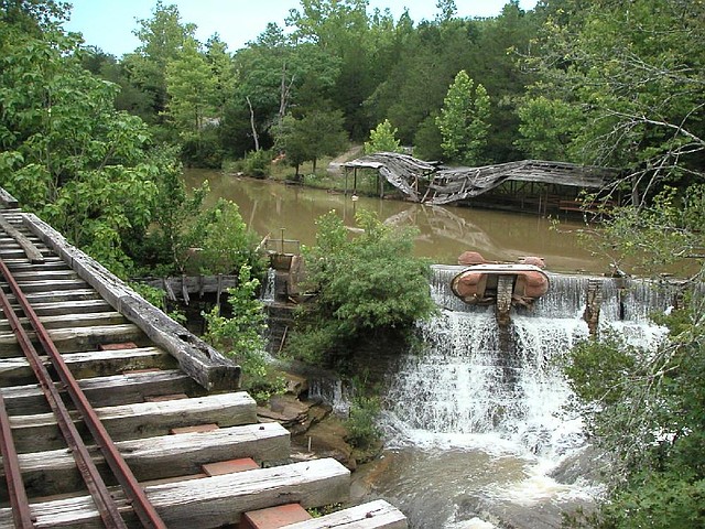 Parts of an old log ride lie in ruins at Dogpatch USA amusement park near Jasper in this 2004 photo. Charles “Bud” Pelsor, who recently bought much of the land around the park, said he plans to clean up Mill Creek and restock it with trout and mussels.