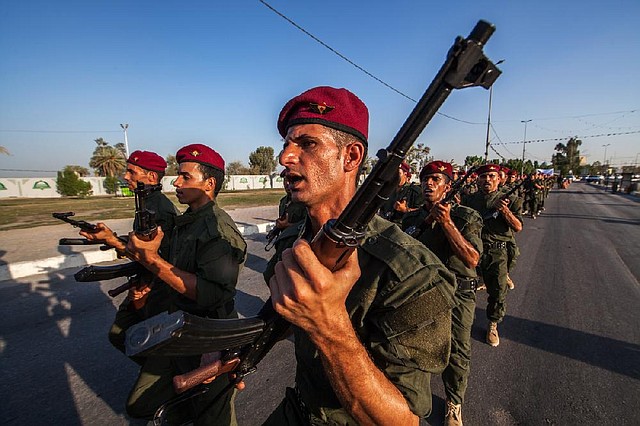 Volunteers in a brigade formed to fight the Islamic State militants parade Thursday near the Imam Hussein shrine in the southern Shiite city of Karbala, 50 miles south of Baghdad.