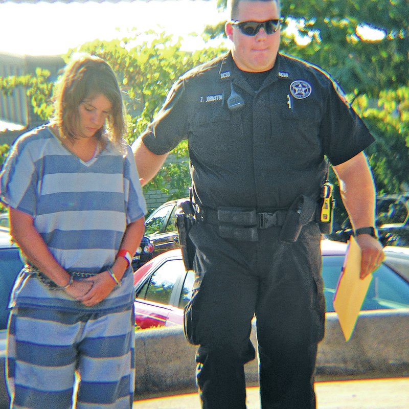 STAFF PHOTO Tracy Neal A Benton County Sheriff&#8217;s Office deputy escorts Mary Faith McCormick, 32, into court for her bond hearing. McCormick, a Siloam Springs teacher, was arrested Wednesday in connection with raping a 13-year-old student. Her bond was set at $50,000.