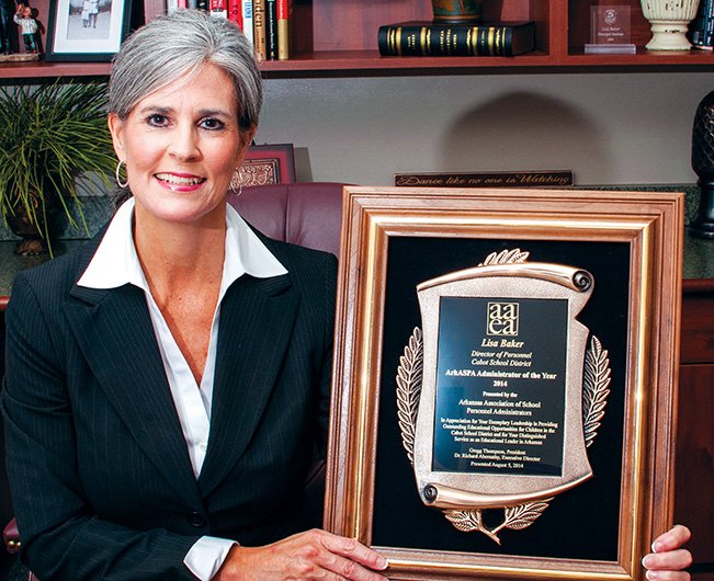 Lisa Baker, director of personnel for the Cabot Public Schools, is shown in her office holding the Arkansas School Personnel Administrator of the Year award from the Arkansas Association of Education Administrators.