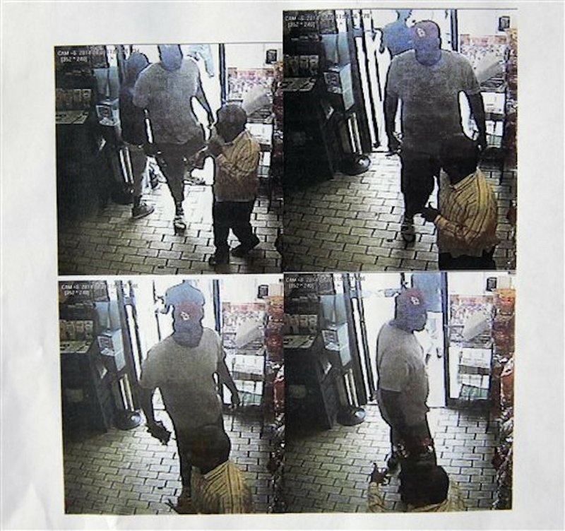 These images provided by the Ferguson Police Department show security camera footage from a convenience store in Ferguson, Mo., on Aug. 9, 2014, the day that Michael Brown was fatally shot by a police officer. A report released Friday, Aug. 15, 2014, by Ferguson Police Chief Thomas Jackson says the footage shows a confrontation between Brown and an employee at the store. The report says that Brown and his friend, Dorian Johnson, stole a box of cigars from the store shortly before Brown's death. 