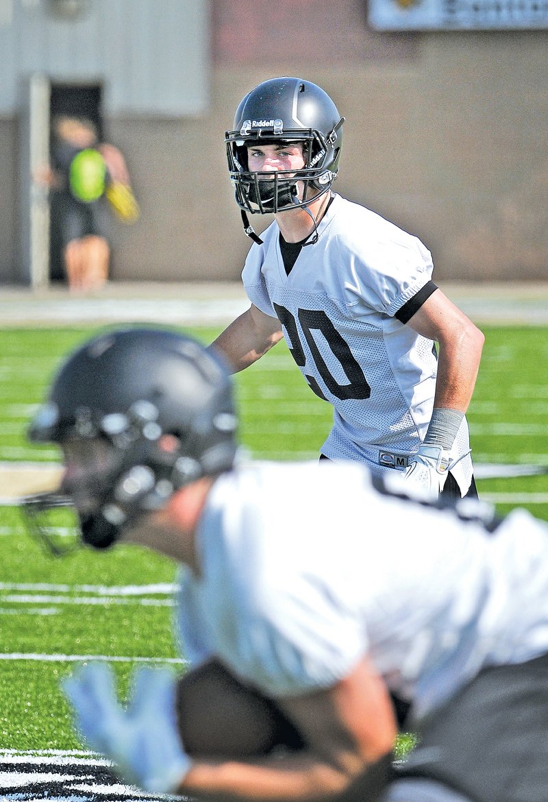  STAFF PHOTO BEN GOFF &#8226; @NWABenGoff Cody Scroggins, Bentonville receiver, looks on as a teammate catches a pass Aug. 4 during the first day of practice at Tiger Stadium in Bentonville.