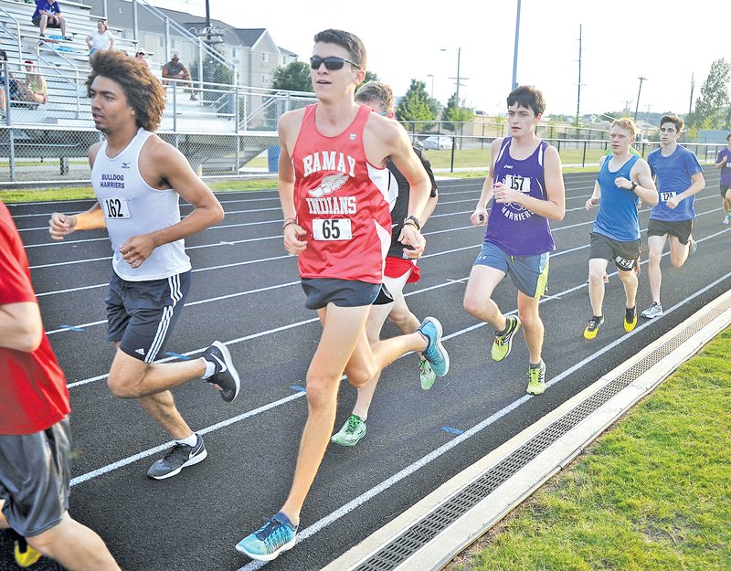 Staff Photo Michael Woods &#8226; @NWAMICHAELW Tevin Whitney, left, and Aiden Swain run in the Solomon Simpson memorial 5K race Friday evening at the Fayetteville Track and Field Complex located at Ramay Junior High School in Fayetteville. Whitney and Swain were friends of Simpson, who died in an accident last year in Missouri.