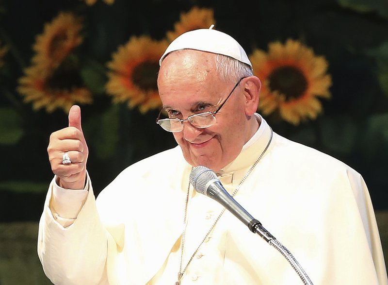 Pope Francis gives a thumbs up during a meeting with Asian youth at the Solmoe Sanctuary in Dangjin, South Korea, Friday, Aug. 15, 2014. Pope Francis urged Catholic youth on Friday to renounce the materialism that afflicts much of Asian society today and reject "inhuman" economic systems that disenfranchise the poor, pressing his economic agenda in one of the region's powerhouses where financial gain is a key barometer of success. 