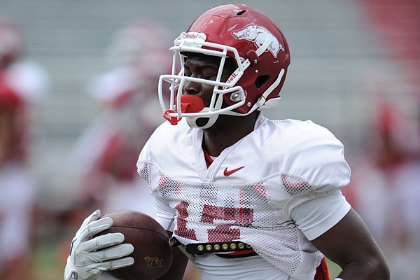 Arkansas freshman receiver Jojo Robinson catches a ball during practice Saturday, Aug. 16, 2014, at Razorback Stadium in Fayetteville.