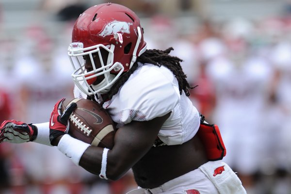 Arkansas sophomore running back Alex Collins carries the ball during practice Saturday, Aug. 16, 2014, at Razorback Stadium in Fayetteville.