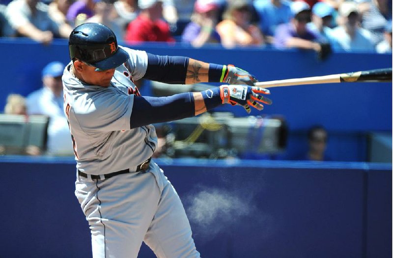 Detroit Tigers' Miguel Cabrera hits a single against the Toronto Blue Jays during the first inning of a baseball game on Sunday, Aug. 10, 2014, in Toronto.  (AP Photo/The Canadian Press, Jon Blacker)