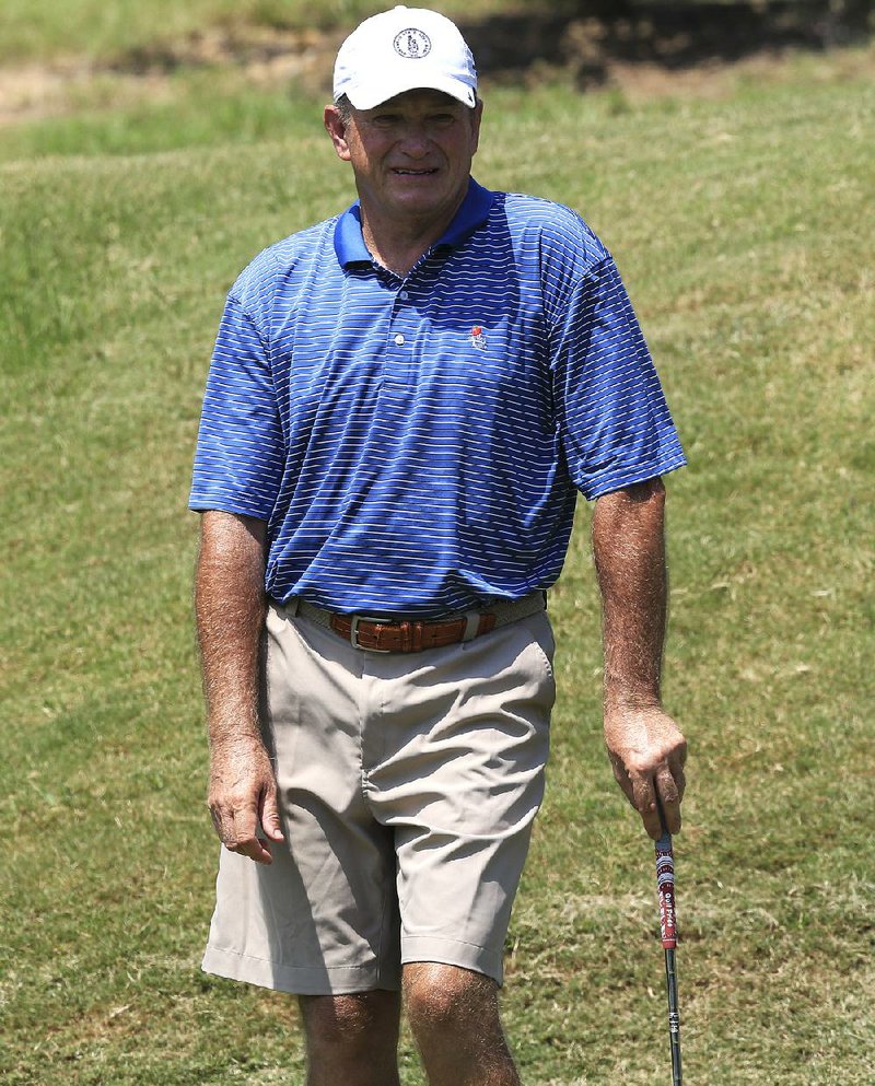  Arkansas Democrat-Gazette/STATON BREIDENTHAL --8/16/14-- Stan Lee watches as his ball rolls past the hole after chipping onto the green Saturday during the ASGA Match Play at The Greens at North Hills in Sherwood.