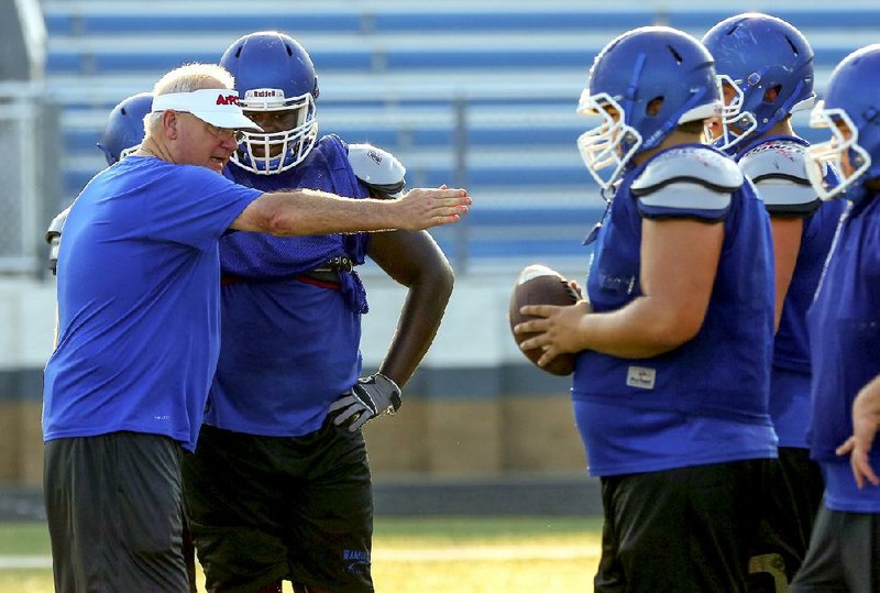 8/11/14
Arkansas Democrat-Gazette/STEPHEN B. THORNTON
Conway High School's offensive line coach Brooks Hollingsworth works during practice Monday in Conway.