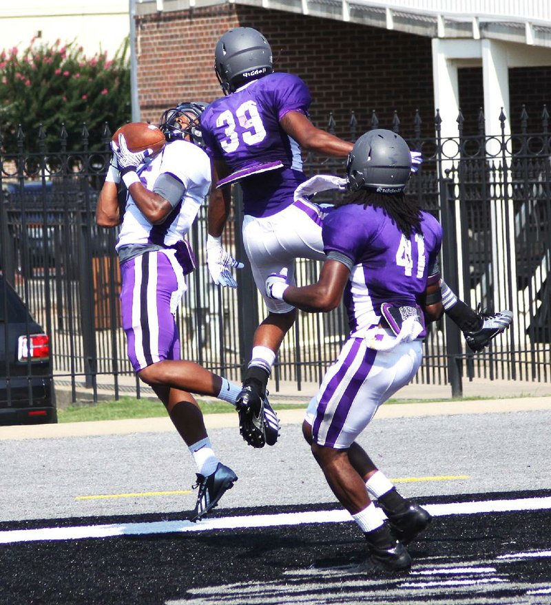 Photo courtesy of Central Arkansas

Central Arkansas receiver Jose Moore (left) hauls in a pass behind two defenders for a touchdown during Saturday’s scrimmage at Estes Stadium.
