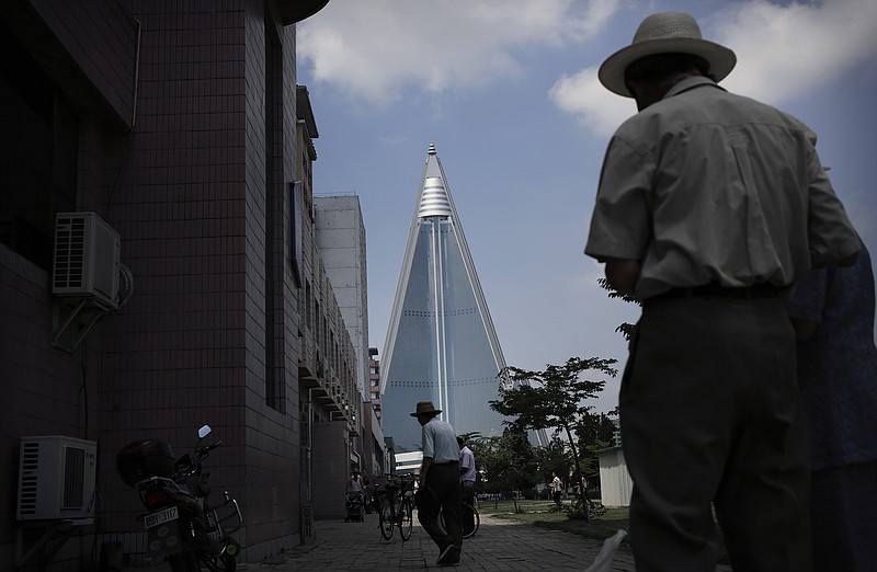 The Associated Press SELECTIVE ASSISTANCE: Elderly North Korean men walk on a sidewalk with the 105-story pyramid-shaped Ryugyong Hotel, which has been under construction since 1987, seen in the background in Pyongyang, North Korea. Home to more than one-tenth of North Korea's 24 million people, Pyongyang has always been the focus of development and the prime beneficiary of state funding. Providing better housing for Pyongyang residents, who have a much higher standard of living than other North Koreans, is a key means for the leadership to ensure their support and loyalty.